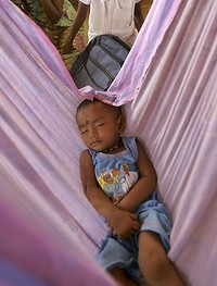 A Tamil child sleeps in a refugee camp in Sri Lanka. The conditions in these camps have been cited as a reason for the exodus of Tamils from the country. Photo: AP