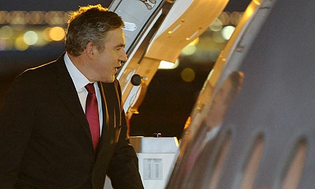 Gordon Brown boards a plane en route to the Commonwealth heads of government meeting. Photograph: Toby Melville/Reuters