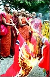 Buddhist monks burn Norwegian flag, 23 December 2002.