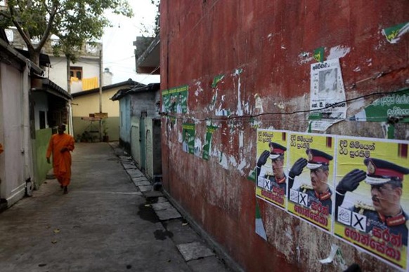AP Election posters of Sri Lankan presidential candidate Sarath Fonseka are seen pasted on a wall in Colombo on Monday.  AP