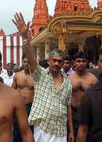 Sarath Fonseka (C) waves to supporters outside the Nallur Hindu temple