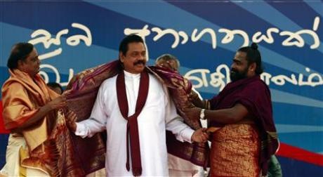 Sri Lanka's President Mahinda Rajapaksa is given a gift by Hindu Tamil holy men at the start of a political rally ahead of the parliamentary elections, in Jaffna about 303 km (188miles) north of Colombo April 1, 2010.The sign reads: Brighter Future.Credit: Reuters Dinuka Liyanawatte