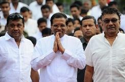 Sri Lankan President Maithripala Sirisena arrives to address the nation from outside the Buddhist Temple of Tooth in the central town of Kandy on January 11, 2015