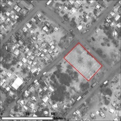 By 6 May 2009, numberous probable internally displaced persons structures are present in this image, along with a graveyard (outlined in red), containing an estimated 195 burials.