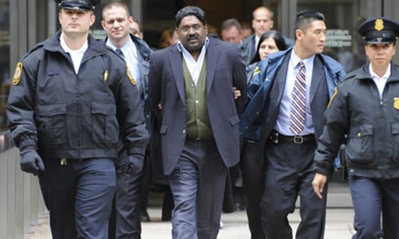 Raj Rajaratnam, billionaire founder of hedge fund Galleon Group, is led in handcuffs by the FBI Photograph: Louis Lanzano AP