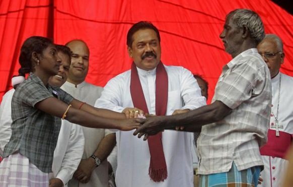 AP Sri Lankan President Mahinda Rajapakse hands over a former child combatant to her parent during a ceremony at Manik Farm in Vavuniya, Sri Lanka on Saturday, Jan. 9, 2010. Photo: AP 