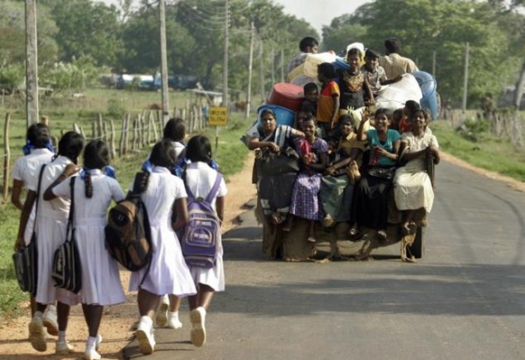 AP In this file photo Sri Lankan Tamil civilians travel on a tractor after being sent home from refugee camps, at Kathankulam village in Mannar. May 18, 2010 marks the first anniversary of the end of the Eelam War IV.  ap