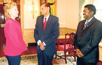 U.S. Secretary of State Hillary Clinton in conversation with External Affairs Minister G.L. Peiris and Ambassador Jaliya Wickramasuriya at the State Department in Washington