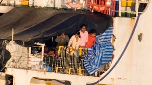 Migrants look over the side of the MV Sun Sea after it was escorted into CFB Esquimalt. (Jonathan Hayward-Canadian Press)