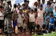 Sri Lankan war-displaced civilians look on at a state-run internment camp in Vavuniya in 2009