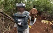 A Sri Lankan de-miner holds up a disabled mine in an area close to Mannar on 6 September, 2010