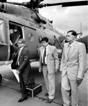 External Affairs Minister S.M. Krishna and his Sri Lankan counterpart, Gamini Lakshman Peiris (right), arrive on a special helicopter at a defence base in Colombo on Thursday. Foreign Secretary Nirupama Rao is seen alighting from the chopper. 