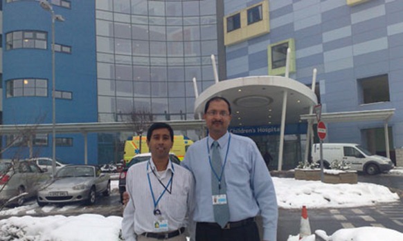 Sri Lankan doctor Anuruddha Padeniya, left, outside the John Radcliffe hospital, Oxford, where he worked during his UK placement. Photograph: GHWA