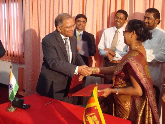 The Hindu Indian High Commissioner to Sri Lanka Ashok K. Kantha and Sri Lankan Ports and Highways Secretary Sujatha Kure exchange documents signing an MoU on the development of the KKS port in the northern province in Colombo on Wednesday. Photo: R.K. Radhakrishnan 