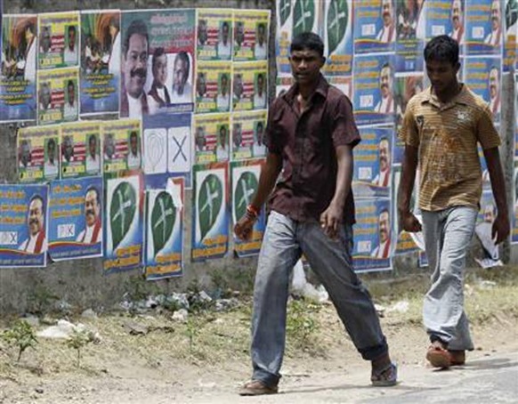 Two boys walk past local government election campaign posters in Jaffna, about 304 km (189 miles) north of Colombo, July 22, 2011. Credit: Reuters Dinuka Liyanawatte