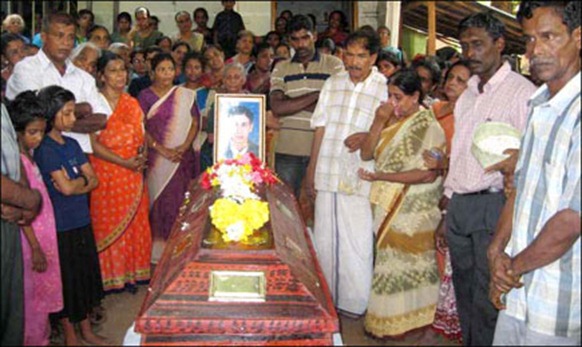 Sealed coffin of a ACF worker killed in Muthur being kept in his residence in Trincomalee for few minutes before taken to cemetery.