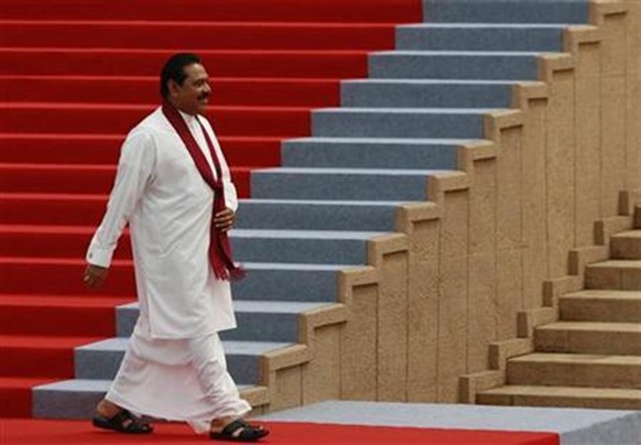 Sri Lankan President Mahinda Rajapaksa smiles as he walks the red carpet at the Presidential Secretariat building after taking the oath of office for a second term in Colombo, November 19, 2010. Credit:Reuters Andrew Caballero-Reynolds