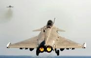 FILE- In this March 29, 2011 file photo provided by the French Army, a Rafale jet fighter takes off from the flight deck of the Charles de Gaulle aircraft carrier in the Mediterranean sea, as part of the Operation Odyssey Dawn. In recent weeks, India has decided to buy 126 fighter jets from France, taken delivery of a nuclear-powered submarine from Russia and worked to ready its first aircraft carrier modernizing its military to face a rising China. (AP Photo/Marine Nationale, Cyril Davesne, File) NO SALES