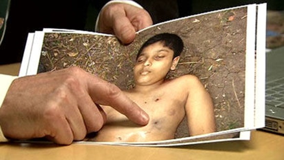 BG DerrickPounder examinies an Image of the Body Balakandran Prabakharan a 12 year old boy