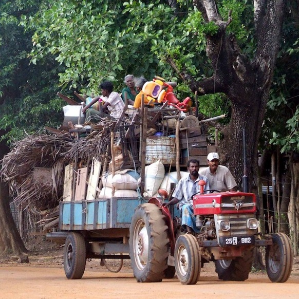 Red_tractor_huge_load._Jan_2009_displacement_in_the_Vanni Image from Wikimedia Commons