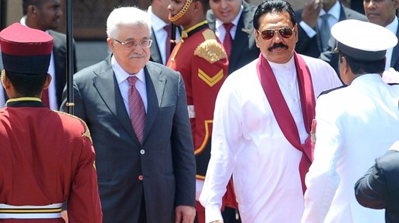 Palestinian President Mahmoud Abbas (2L) walks with Sri Lankan President Mahinda Rajapakse (3R) upon his arrival in Colombo on April 16, 2012. The Palestinian leader arrived on a two-day visit to the island. AFP PHOTO