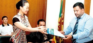 Picture shows Ms Song Jianhua presenting her firm’s investment profile to Rishad Bathiudeen, Minister of Industry and Commerce