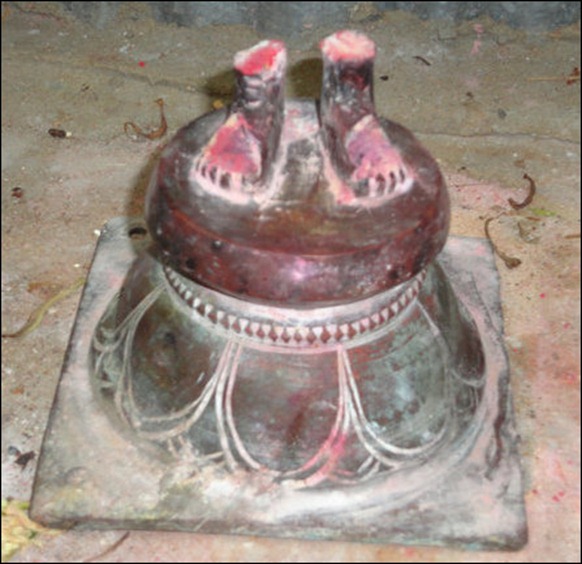 The rare bronze image of the deity Kooddaththaar found sawed off in the Sinhala Army-occupied ‘High Security Zone’ at I'lavaalai in Jaffna. The image of the collective deity of the Tamil guild of soldiers of the ancient times, was in anthropomorphic form. Note that despite the idol missing, the local Tamil devotees have applied saffron in reverence to the the remaining part. [Image courtesy: History Department, University of Jaffna]