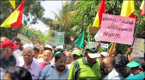 Sampanthan and Suresh walk under a placard in flawed Tamil brought by the UNP supporting southerners