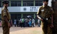 Policemen stand guard over a group of ethnic Sri Lankan Tamil residents from the northern Jaffna peninsula (AFP/File, Ishara S. Kodikara)