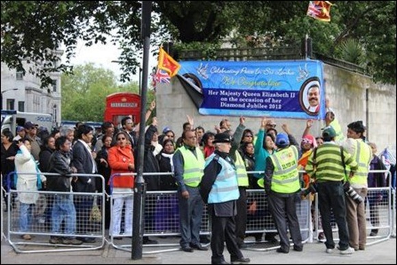 Sinhalese supporting Rajapaksa carrying Sri Lankan Lion flags outside Park Lane Hilton Hotel