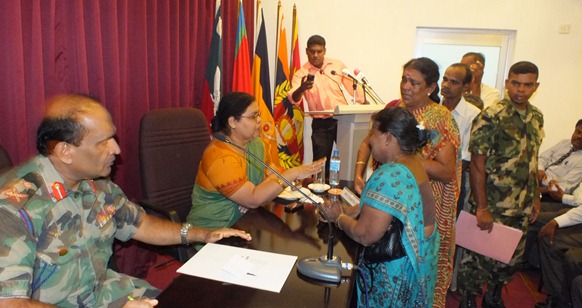 Hathurusinghe brushing aside pleadings and the Jaffna University Vice Chancellor Prof Vasanthy Arasaratnam conveying that to the parents of the detained student leaders. Hathurusinghe's right hand wrist is full of ‘sacred threads’ tied on to it to protect him from danger. This is an ancient Dravidian practice continued by Buddhism of the Sinhalese.