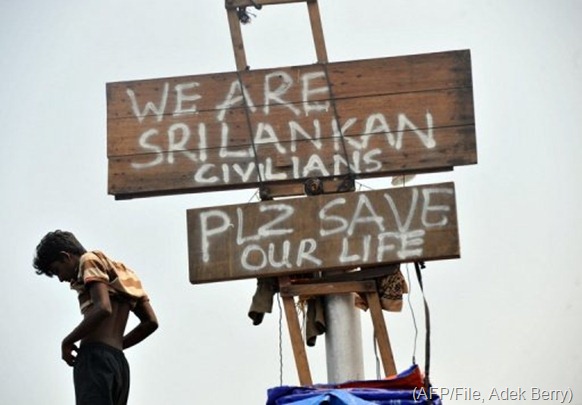 A Sri Lankan asylum seeker stands next to signs on a boat moored at Indonesia's Java island on October 22, 2009 (AFP/File, Adek Berry)