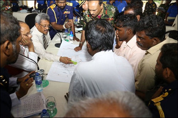 Gotabhaya explains his plans for ‘state of the art’ village adjacent to SL military base to the uprooted Tamil villagers [Photo courtesy: SL Defence website]