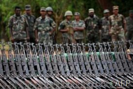 Image taken on April 24, 2009 shows army soldiers standing next to weapons captured from the Tamil Tigers in Sri Lanka (AFP/File, Pedro Ugarte)