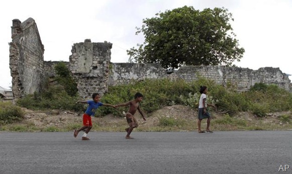 AP In this July 25, 2011 photo, Sri Lankan ethnic Tamil children play in front of a war damaged building in Jaffna, Sri Lanka. For the ethnic Tamils living in the former war zone in the north, it is still a saga of haunted memories, military occupation and missing loved ones. 